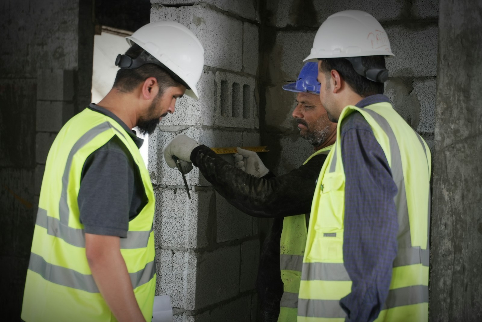 Construction workers in safety gear on a building site